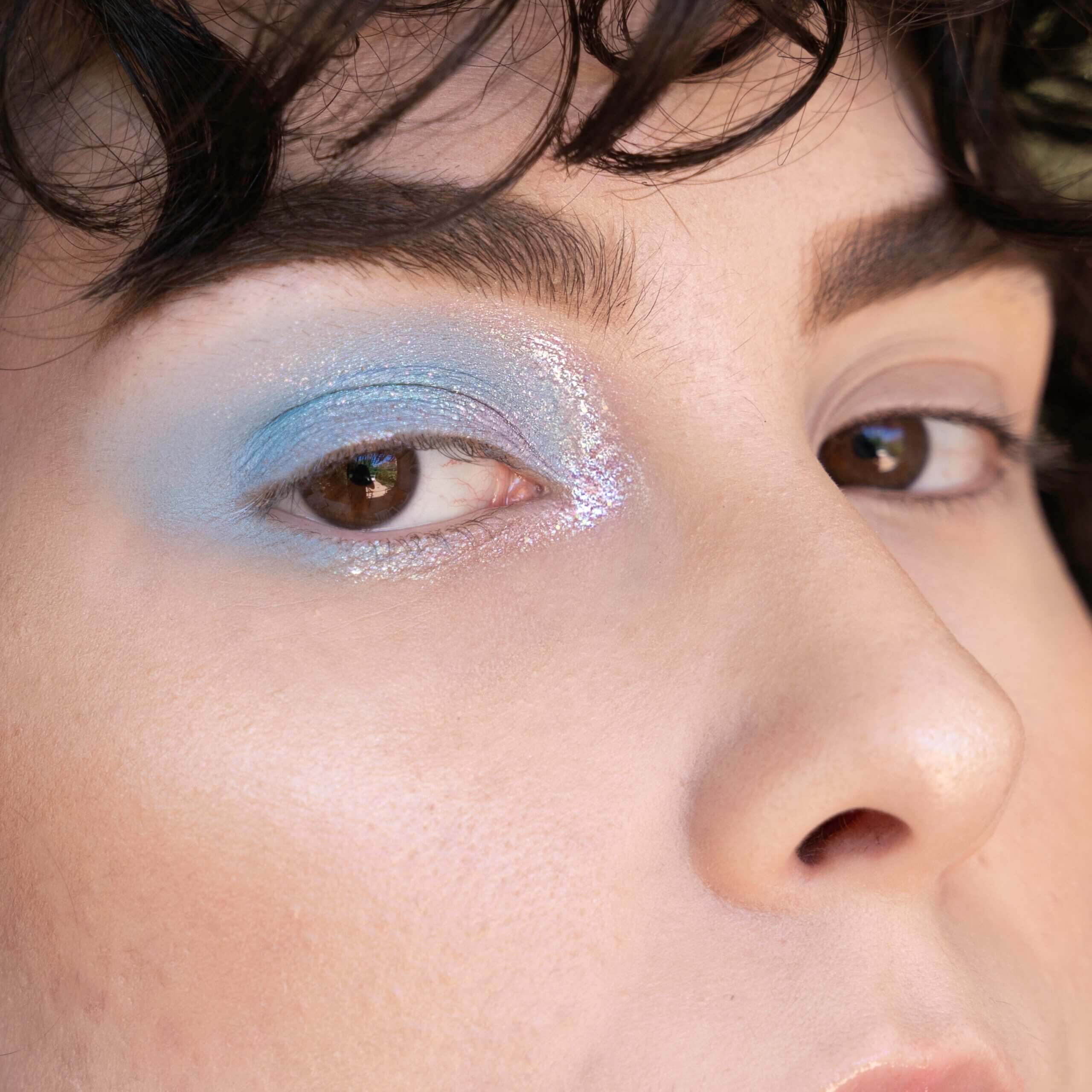 Blend vibrant y2k blue eyeshadow for a striking retro look in 2023